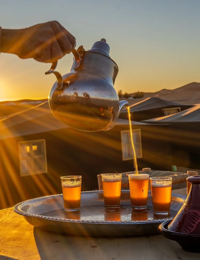 Mint tea poured at sunset in the desert