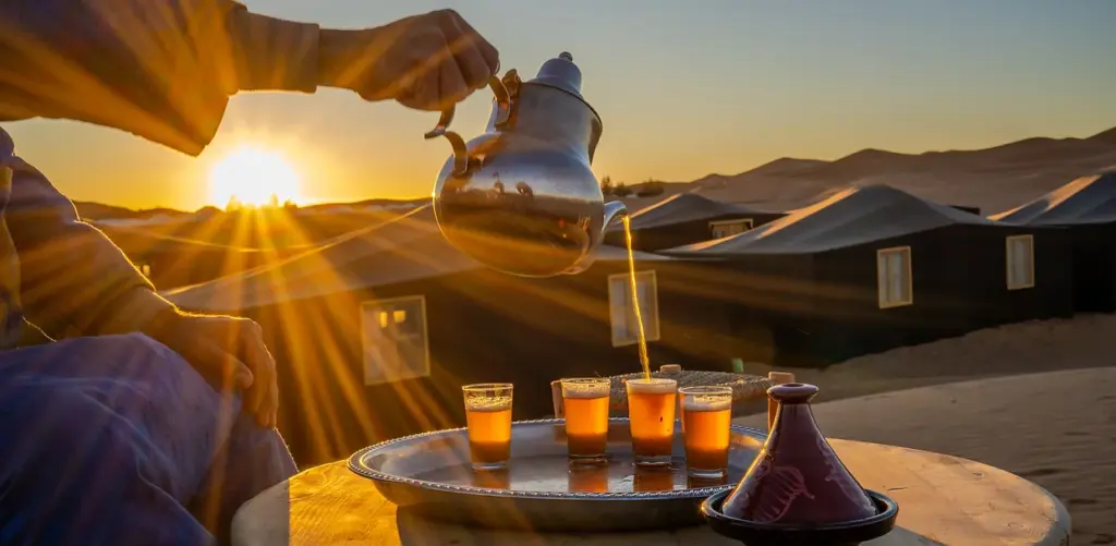 Mint tea poured at sunset in the desert