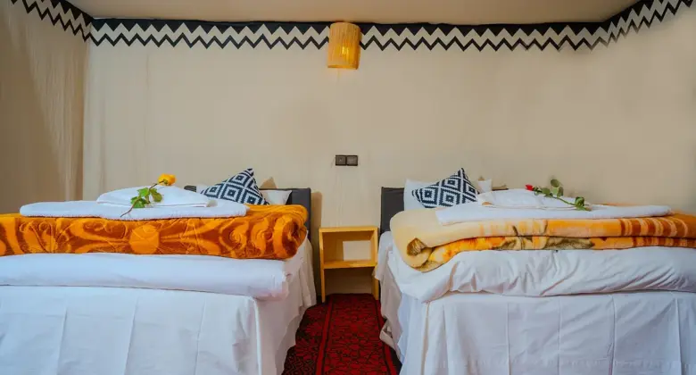 Twin beds in a traditional desert tent