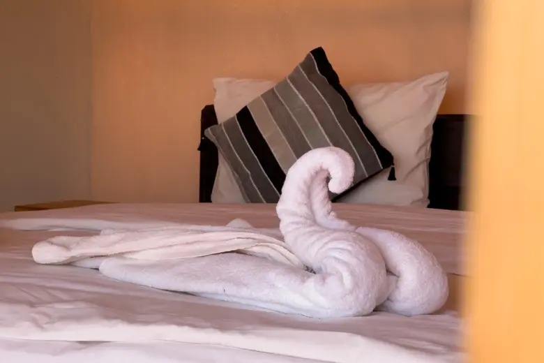 Towel decoration on a tent bed