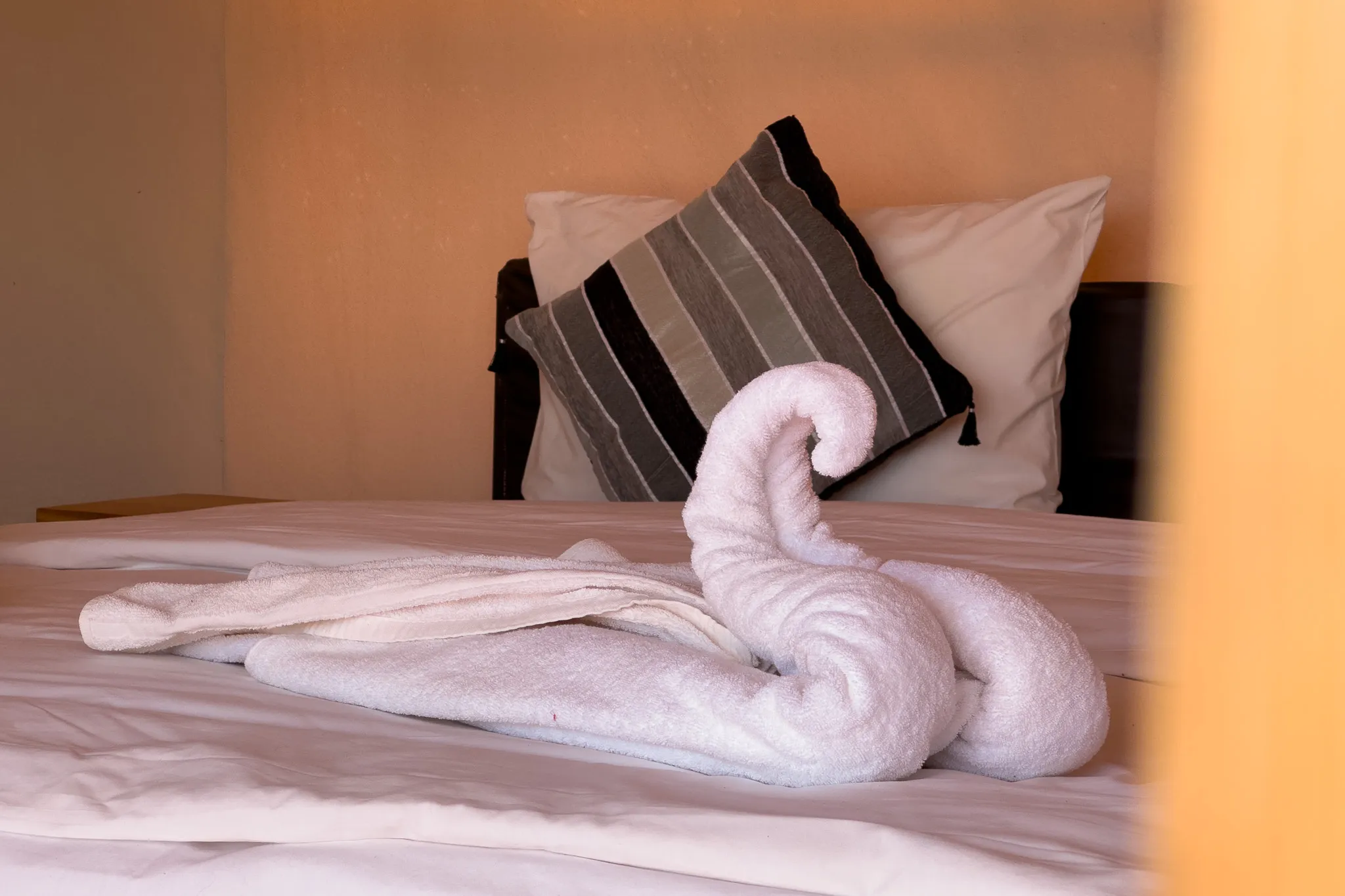 Towel decoration on a tent bed