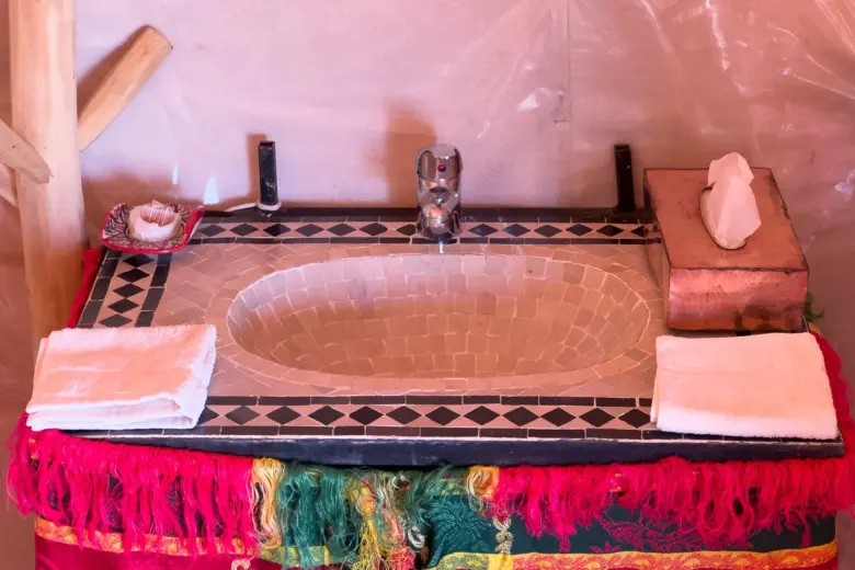 Moroccan zellige sink in a tent bathroom