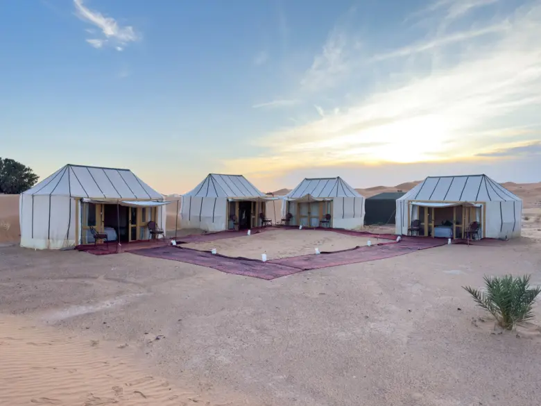 Ame Camp tents around a carpeted courtyard