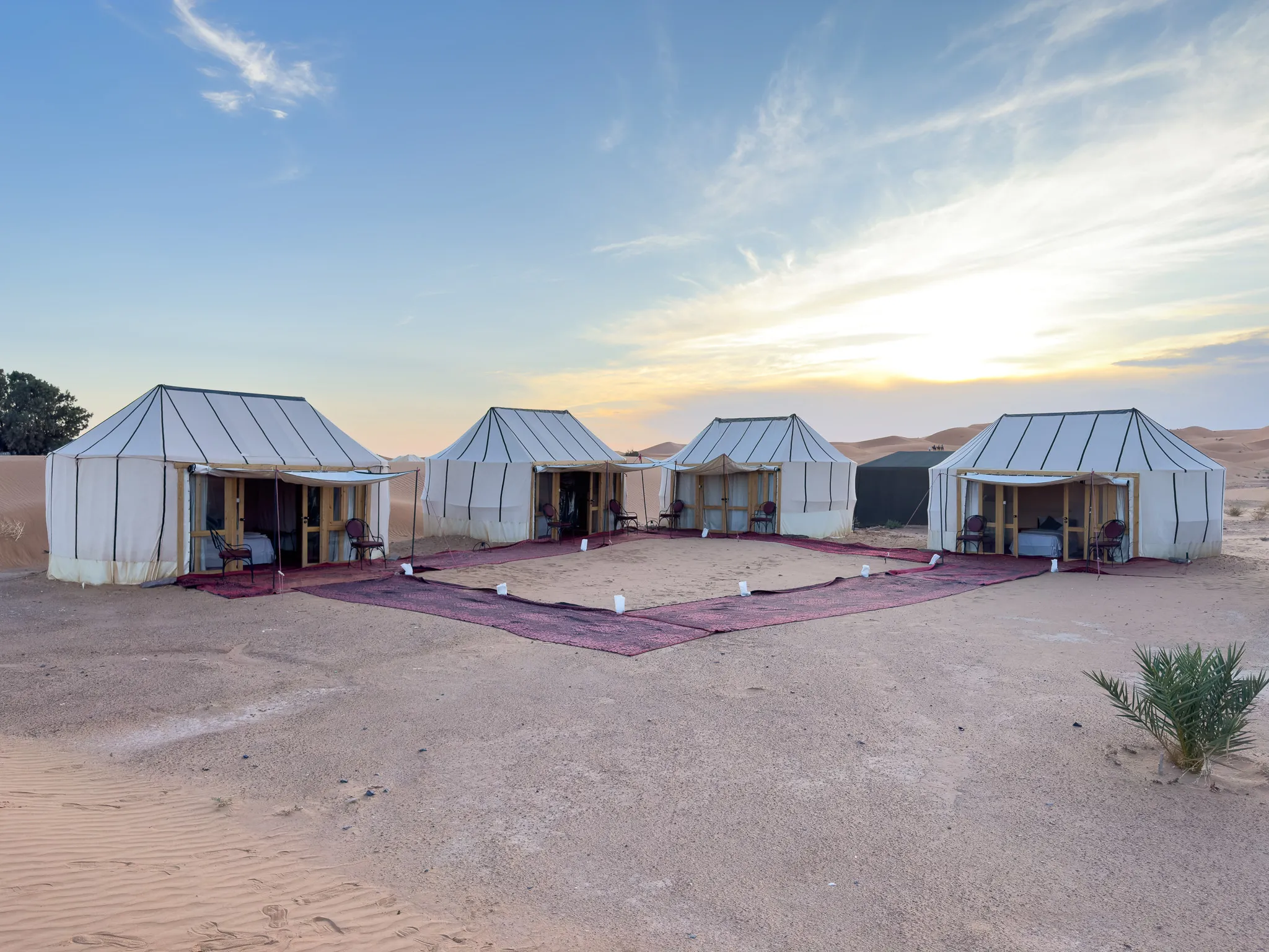 Ame Camp tents around a carpeted courtyard