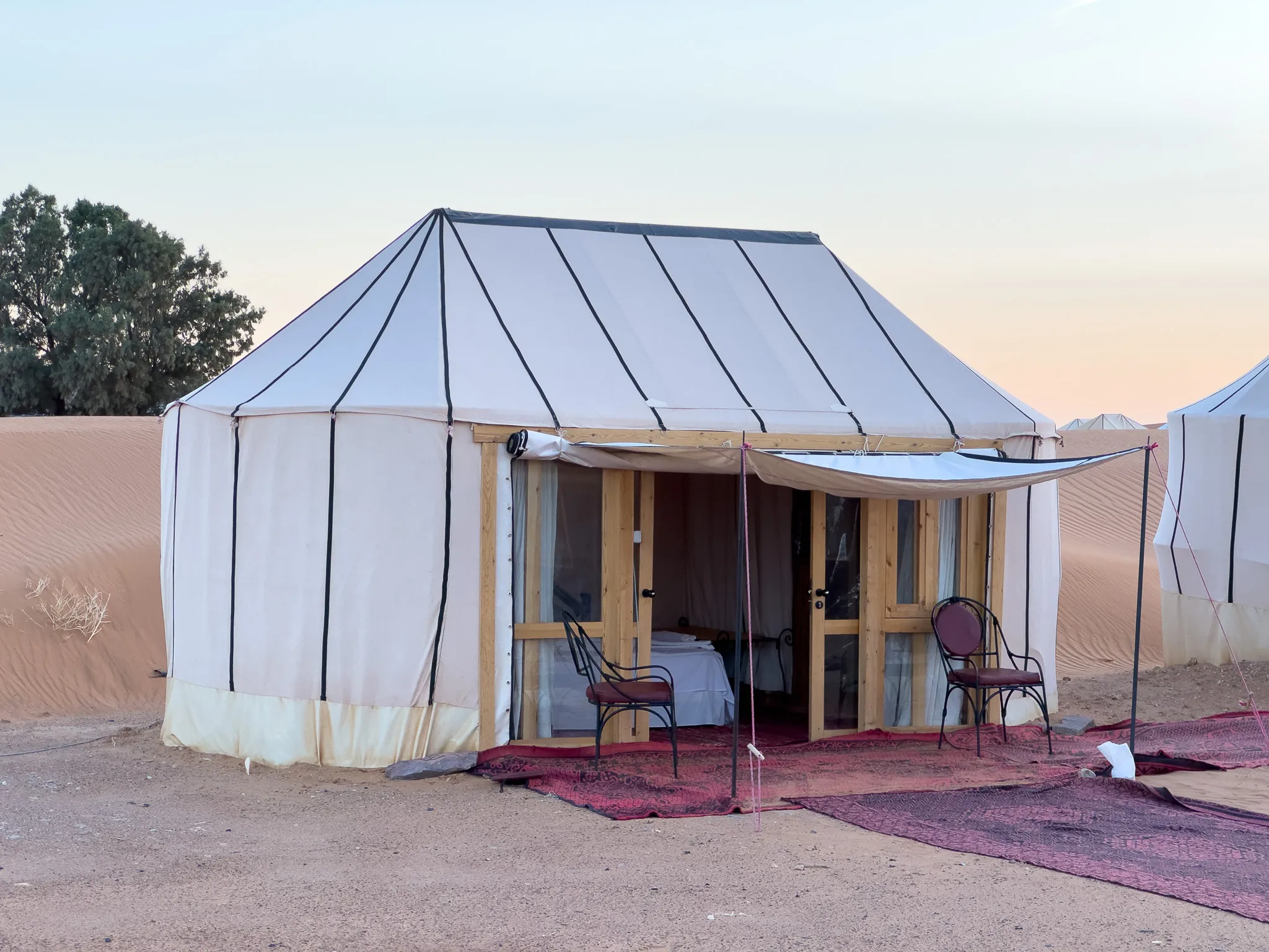 Guest tent with a shaded terrace at Ame Camp