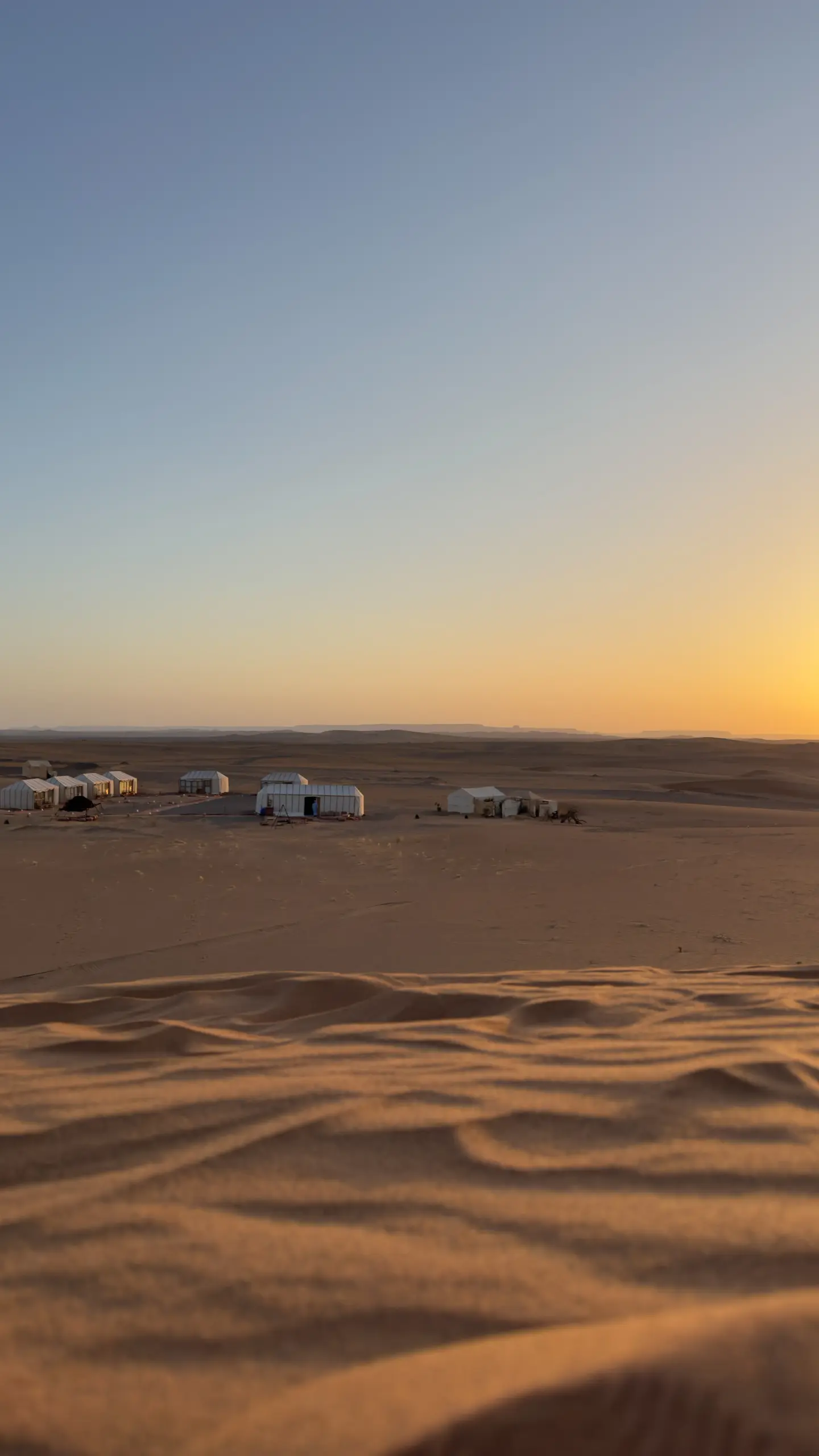Ame Camp tents among the dunes at sunset