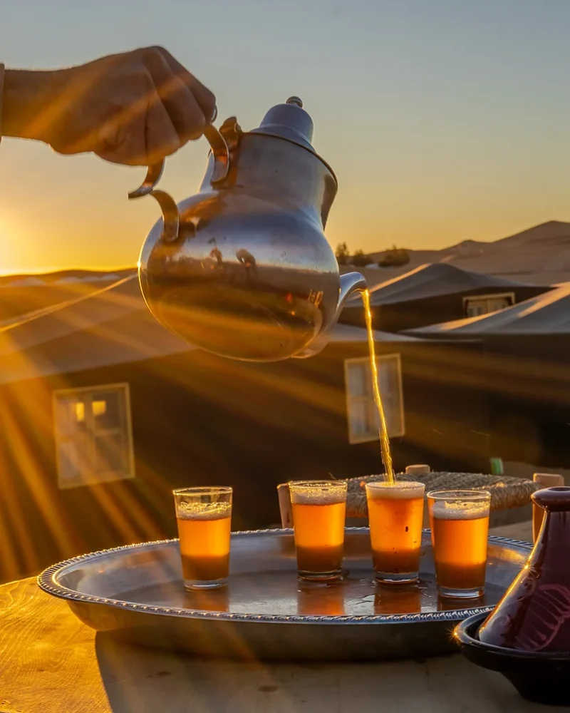 Mint tea poured at sunset in the desert
