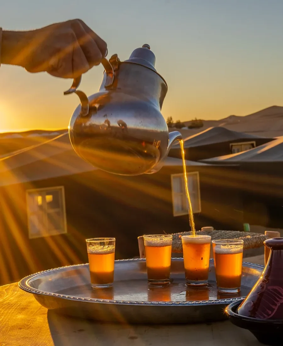 Mint tea poured at sunset in the desert