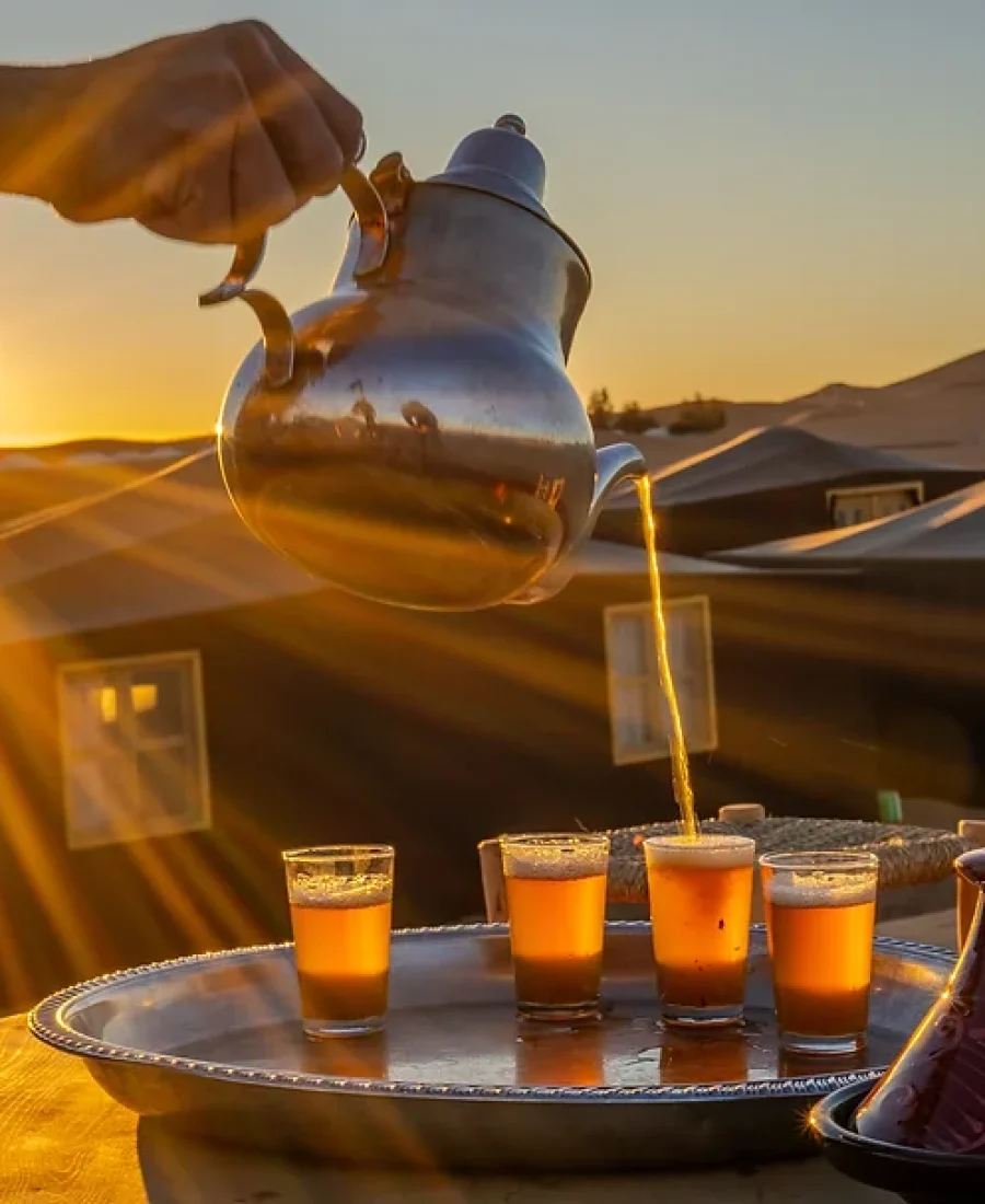 Mint tea poured at sunset in the desert