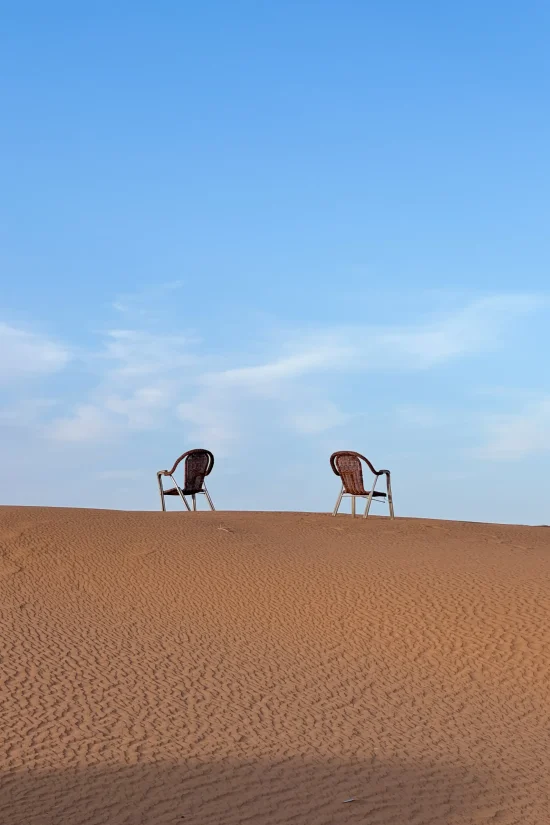 Two chairs on a sand dune