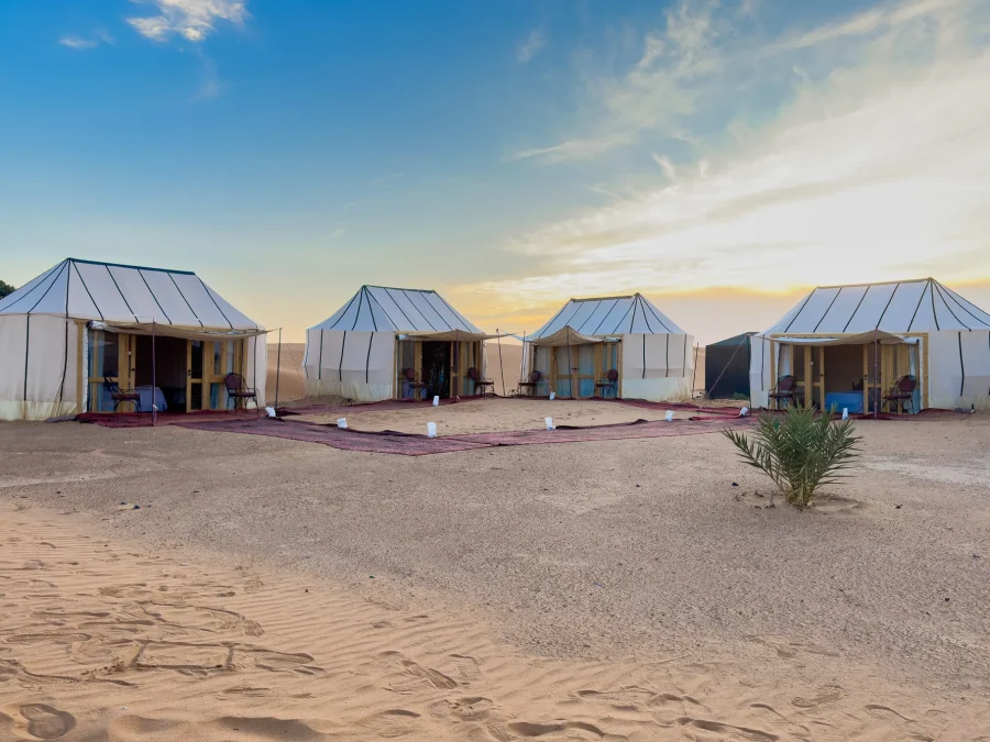 Row of white guest tents at Ame Camp